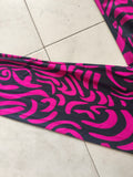 Girls full-zip long sleeve jumpsuit with swirling pink tribal print. Slim stretch fit one-piece costume, sleek full-length design, great for dance performance, cosplay and loungewear dress-up.