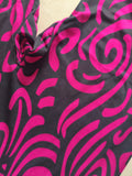 Girls full-zip long sleeve jumpsuit with swirling pink tribal print. Slim stretch fit one-piece costume, sleek full-length design, great for dance performance, cosplay and loungewear dress-up.
