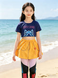 Girls 3-piece street dance outfit, letter print cropped short sleeve tee, chain & tassel decorated skort and color block leggings. Bright color matching, lightweight fabric for beach outings and stage performance dress-up.