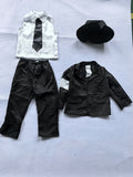 Boys classic black dance suit set, blazer, straight trousers, white shirt, tie and fedora hat. Unique white arm patch detail, sleek formal silhouette, ideal for pop dance performance and talent show costume dress-up.